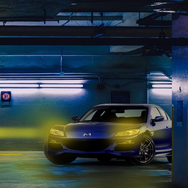 Voiture jaune dans un parking souterrain éclairé de néons, flèche de sortie, salle 60 minutes chrono, Escape Yourself à Lanester
