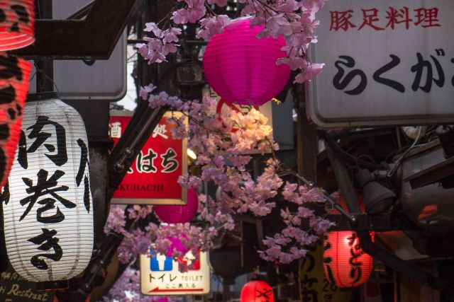 Ruelle japonaise décorée de lanternes rouges et fleurs roses, ambiance yakuza chez Closed Escape Game