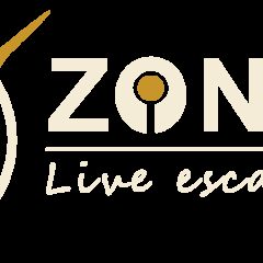 Logo de Zone 72, escape game au Mans, avec aiguilles dorées et cible concentrique