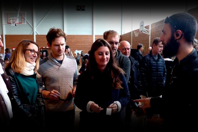 Groupe de joueurs échangeant avec un animateur dans une salle des fêtes, Immersiv'Game à Edern