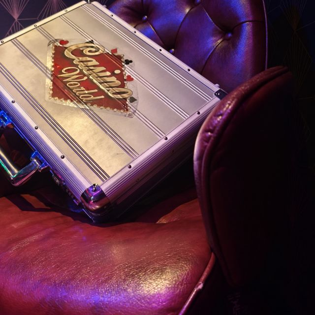 Mallette métallique posée sur un fauteuil capitonné violet, salle 2006 Hold-up à Vegas chez Le Chemin de Traverse