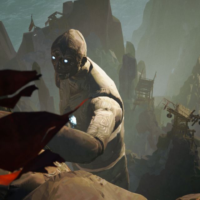 Personnage de pierre aux yeux lumineux et à la cape rouge dans un décor rocheux, jeu Ascenders chez Inoui VR à Lille