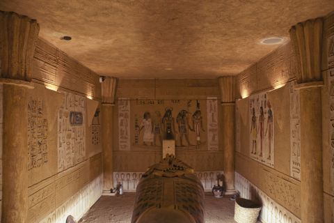 Chambre funéraire égyptienne avec sarcophage, hiéroglyphes et colonnes sculptées