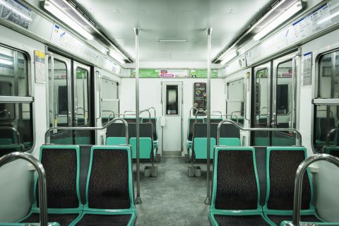 Intérieur de rame de métro avec sièges turquoise et gris, chez The Game à Paris