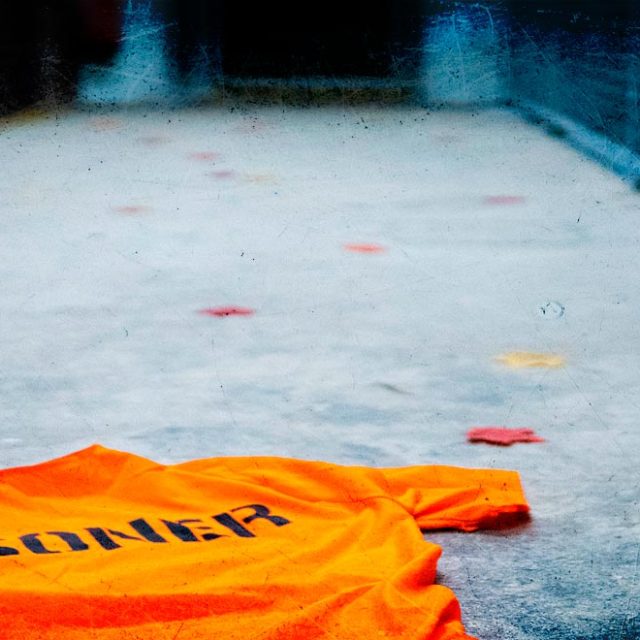 Scène de crime en prison : une enveloppe orange "Biohazard" sur le sol gris tacheté