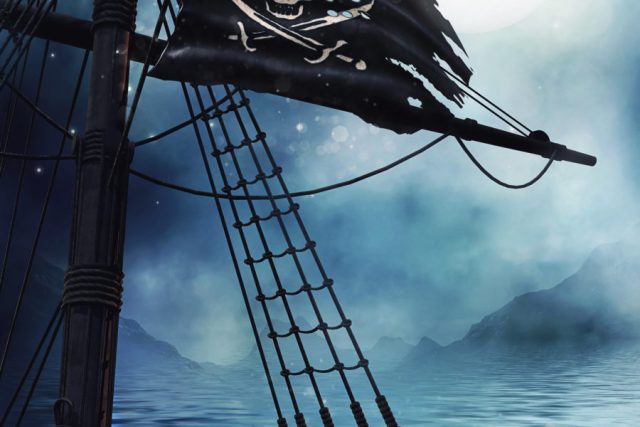 Mât d'un voilier avec drapeau pirate sur une mer brumeuse, salle Le bateau pirate chez Deadline Escape Game au Thor
