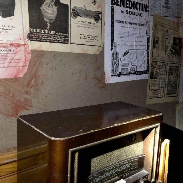 Radio ancienne en bois sous des affiches collées au mur, salle Les explorateurs urbains chez Move To Aixit