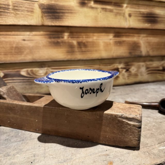 Bol blanc et bleu portant un prénom sur un billot de bois, salle Le secret du paludier chez Escape Factory à Guérande